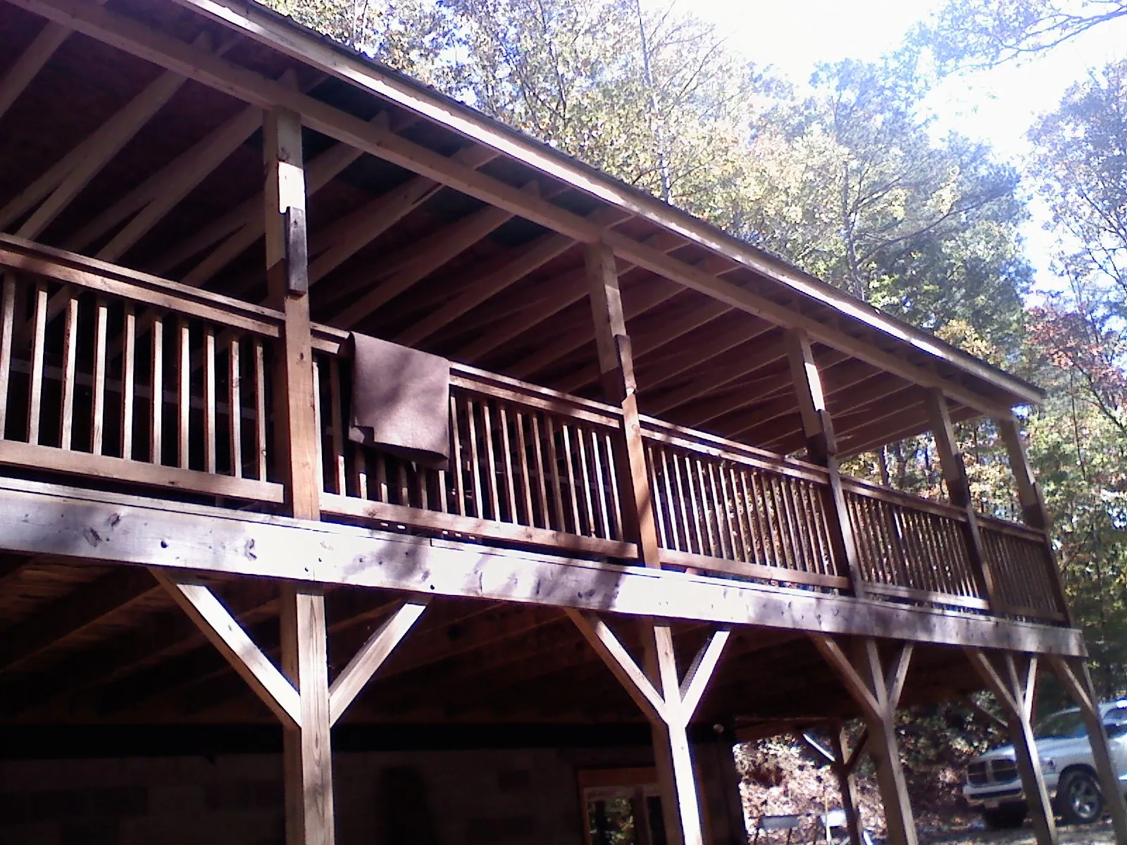 Timber framing under a new elevated porch and deck — Roof Leak Repair in Ira by Roofing Brothers